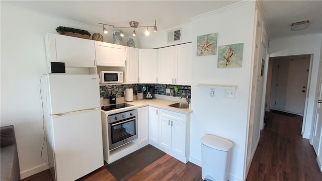 kitchen featuring tasteful backsplash, crown molding, white cabinetry, sink, and white appliances