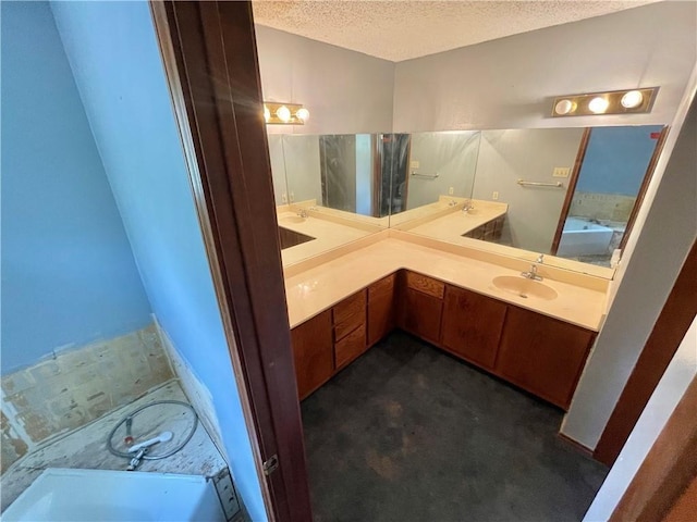 4401 River Valley Dr Unit 205, Corpus Christi, TX 78410 - full bathroom featuring a textured ceiling, a garden tub, and double vanity
