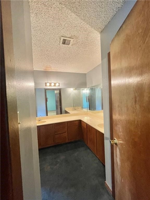 bathroom featuring vanity and a textured ceiling