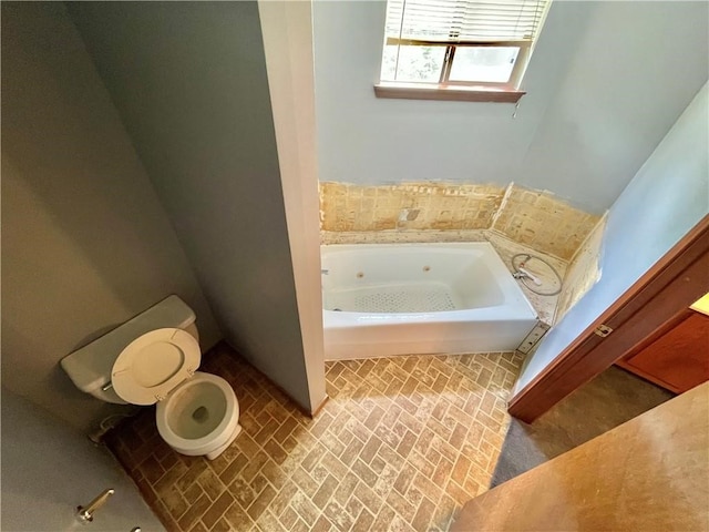 bathroom with toilet and a tub