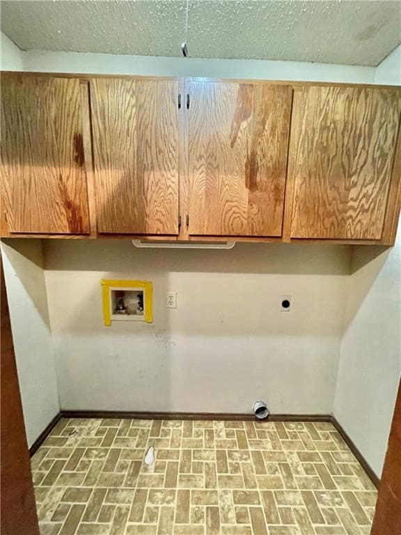 laundry room with hookup for an electric dryer, washer hookup, and cabinets