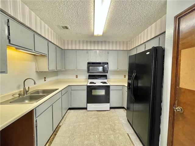 kitchen with sink, black appliances, a textured ceiling, light tile patterned floors, and gray cabinetry