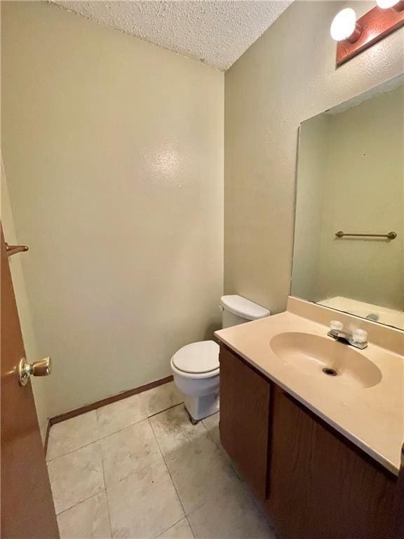 4401 River Valley Dr Unit 205, Corpus Christi, TX 78410 - bathroom featuring a textured ceiling, toilet, vanity, and tile patterned floors