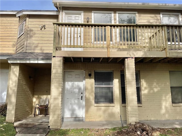 back of property with a balcony