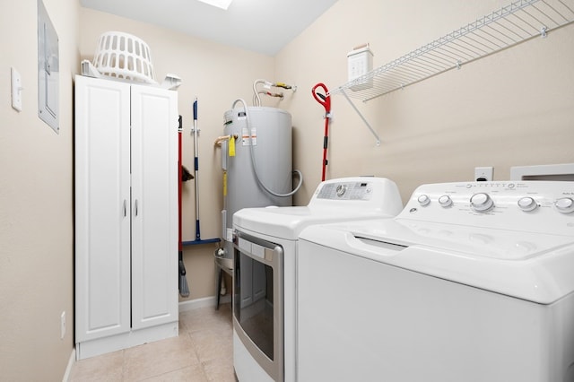 washroom featuring independent washer and dryer, light tile patterned flooring, baseboards, and electric panel