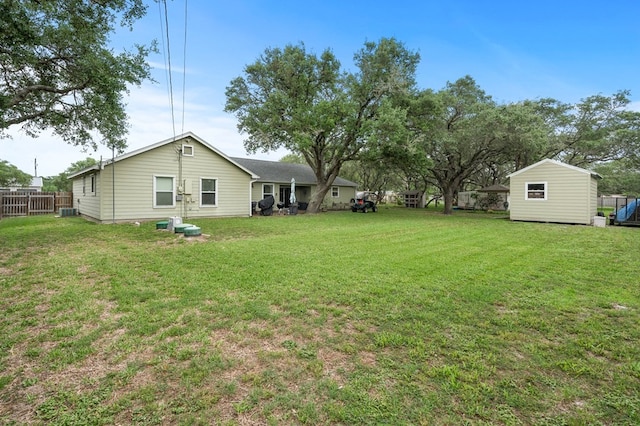 view of yard with fence and an outdoor structure