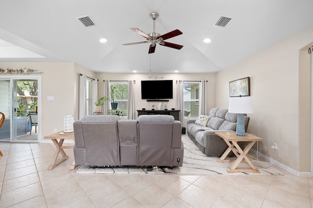 living area featuring baseboards, visible vents, ceiling fan, and lofted ceiling