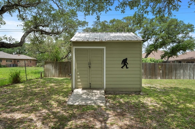 view of shed with a fenced backyard