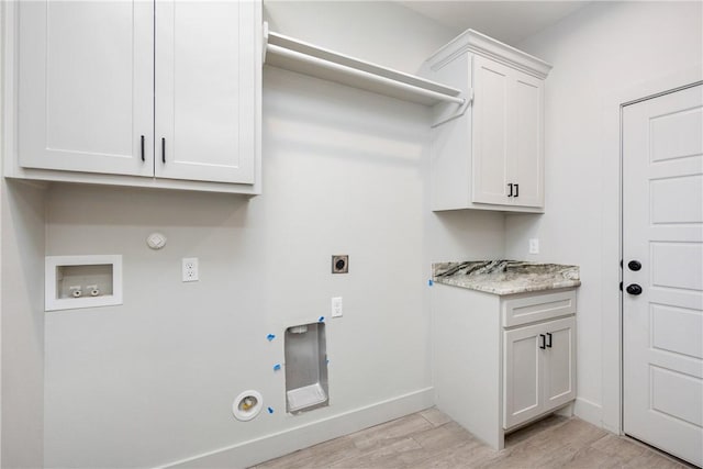 washroom featuring electric dryer hookup, gas dryer hookup, hookup for a washing machine, and light hardwood / wood-style flooring