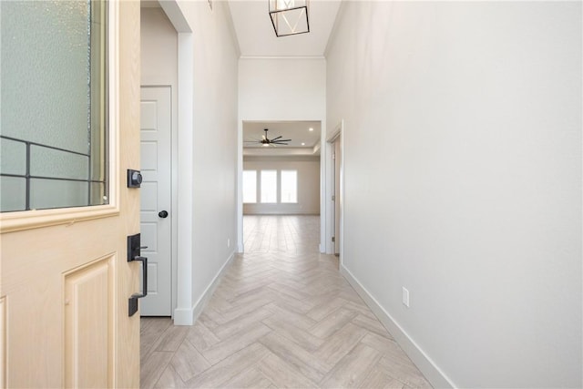 hall with light parquet flooring and ornamental molding