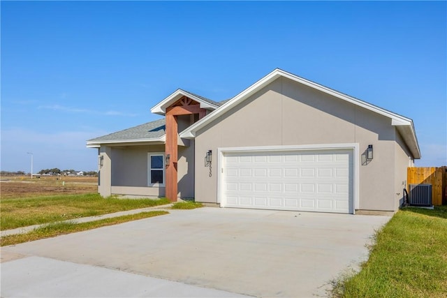 ranch-style house featuring a garage and central air condition unit