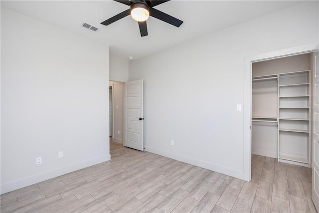 unfurnished bedroom with light wood-type flooring, a closet, and ceiling fan