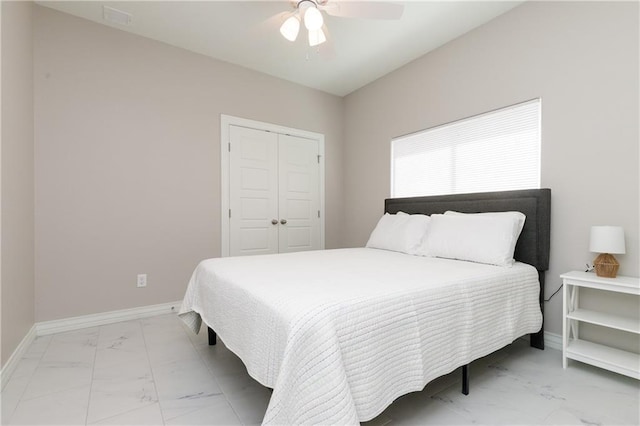 bedroom with ceiling fan and a closet