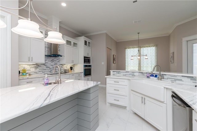 kitchen with pendant lighting, sink, white cabinetry, stainless steel appliances, and light stone countertops