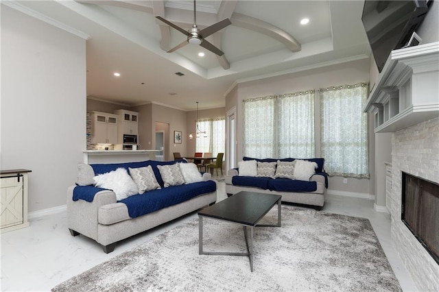 living room featuring a fireplace, ornamental molding, and ceiling fan