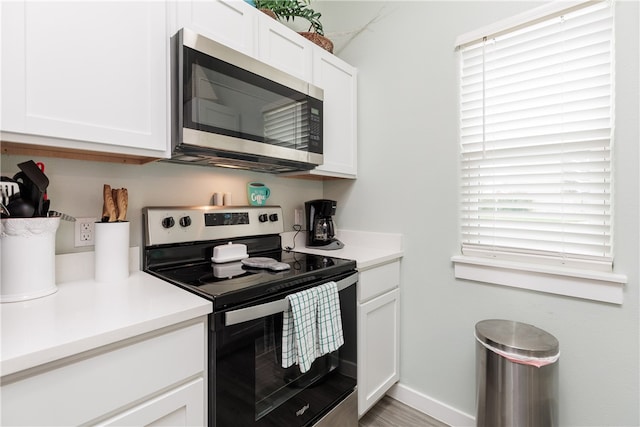 kitchen with white cabinetry and appliances with stainless steel finishes