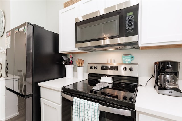 kitchen featuring white cabinetry, hardwood / wood-style floors, and stainless steel appliances