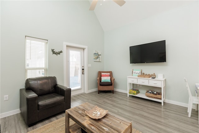 living room with high vaulted ceiling, light hardwood / wood-style flooring, and ceiling fan