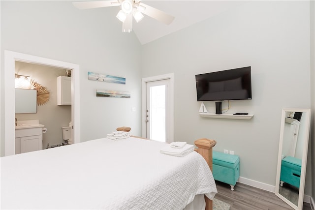 bedroom with hardwood / wood-style floors, ceiling fan, vaulted ceiling, and ensuite bath