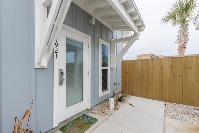 view of exterior entry with a patio