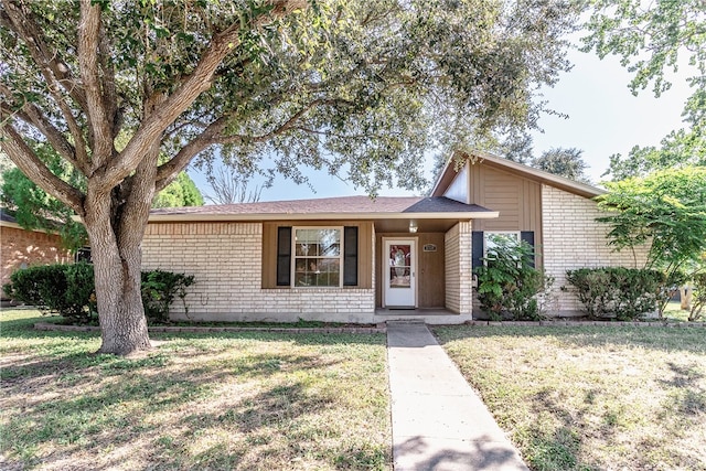 ranch-style home with a front lawn