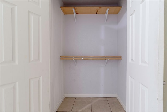 spacious closet with light tile patterned floors