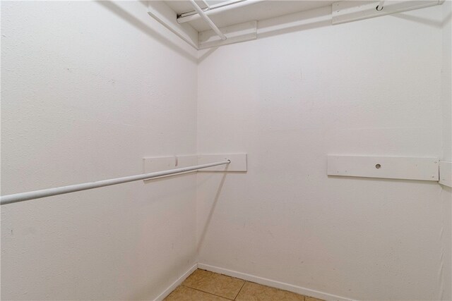 walk in closet featuring tile patterned flooring