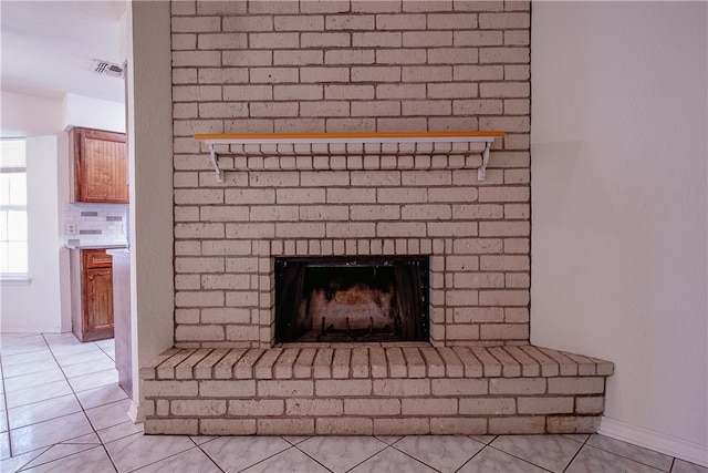 room details featuring a fireplace and tile patterned floors