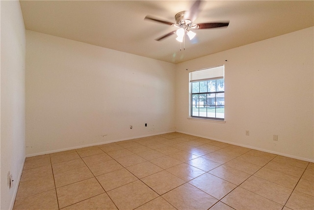 spare room with light tile patterned flooring and ceiling fan