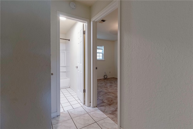 corridor featuring light tile patterned flooring