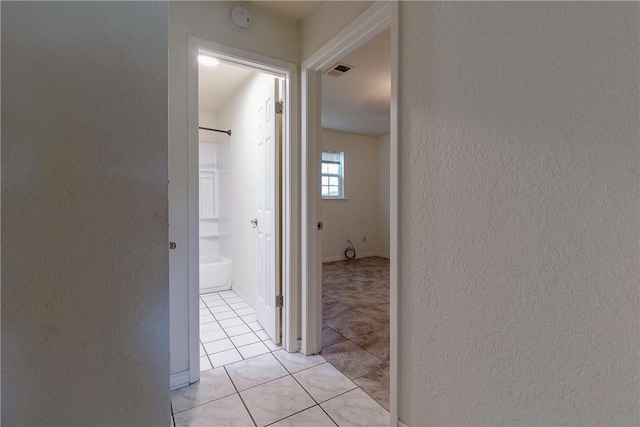 2738 Wind Rock Dr, Corpus Christi, TX 78410 - hallway with a textured wall and light tile patterned floors
