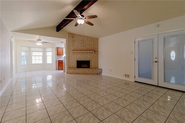 unfurnished living room with french doors, vaulted ceiling with beams, light tile patterned floors, ceiling fan, and a fireplace