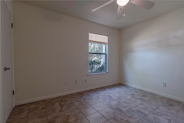 empty room with light tile patterned flooring and ceiling fan