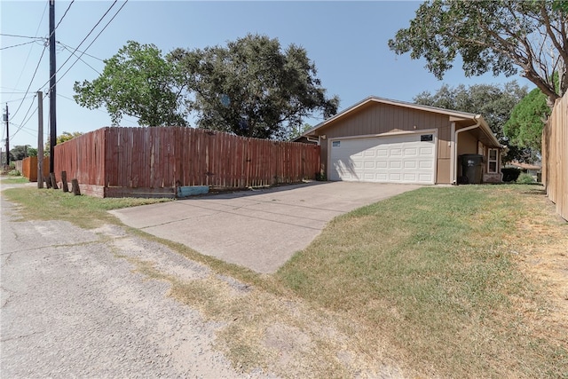 view of property exterior featuring a garage and a lawn