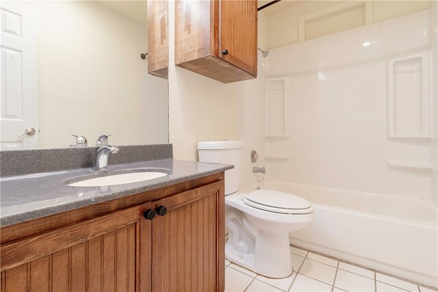 full bathroom with washtub / shower combination, tile patterned flooring, toilet, and vanity