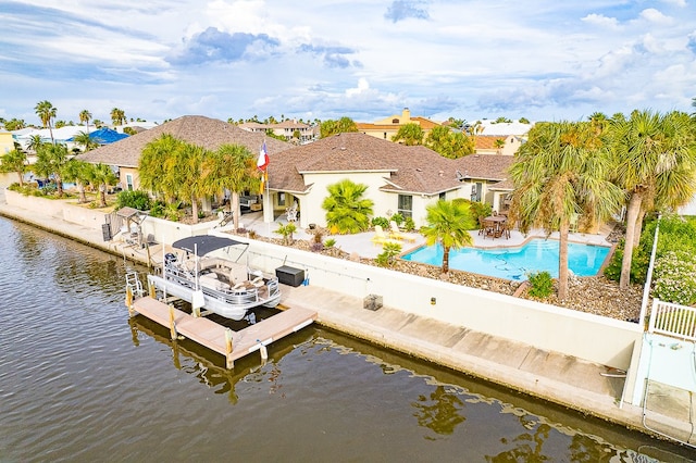 exterior space with a water view and a patio area