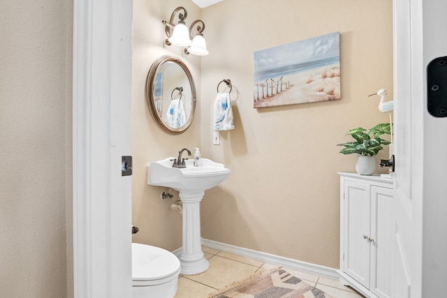 bathroom featuring tile patterned flooring and toilet