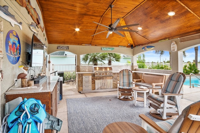 view of patio / terrace with ceiling fan, a grill, and exterior kitchen