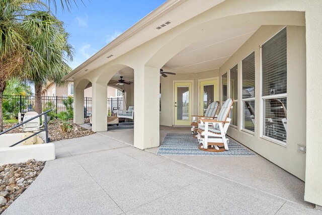 view of patio featuring french doors and ceiling fan