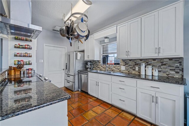15641 Three Fathoms Bank Dr, Corpus Christi, TX 78418 - kitchen with exhaust hood, stainless steel appliances, a sink, tasteful backsplash, and white cabinets