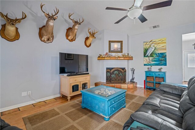 15641 Three Fathoms Bank Dr, Corpus Christi, TX 78418 - living area featuring wood finished floors, a fireplace with raised hearth, baseboards, a ceiling fan, and vaulted ceiling