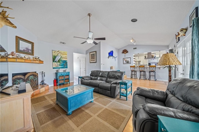 15641 Three Fathoms Bank Dr, Corpus Christi, TX 78418 - living room featuring lofted ceiling, a ceiling fan, light wood-style floors, and baseboards