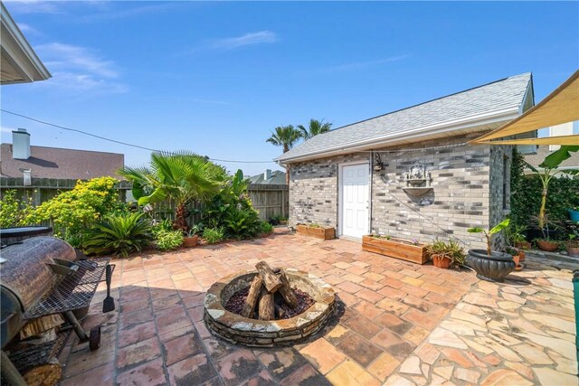15641 Three Fathoms Bank Dr, Corpus Christi, TX 78418 - fenced backyard with a patio and an outdoor fire pit
