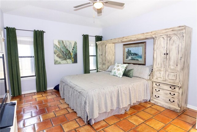 15641 Three Fathoms Bank Dr, Corpus Christi, TX 78418 - bedroom featuring baseboards, light tile patterned floors, and a ceiling fan