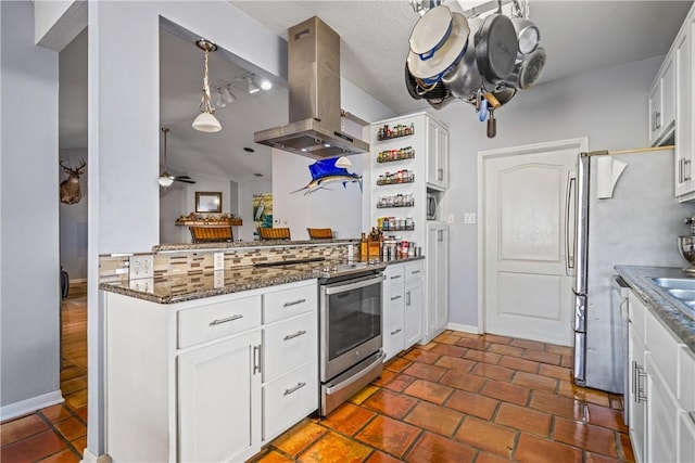 15641 Three Fathoms Bank Dr, Corpus Christi, TX 78418 - kitchen featuring island range hood, electric stove, white cabinetry, dark stone countertops, and ceiling fan