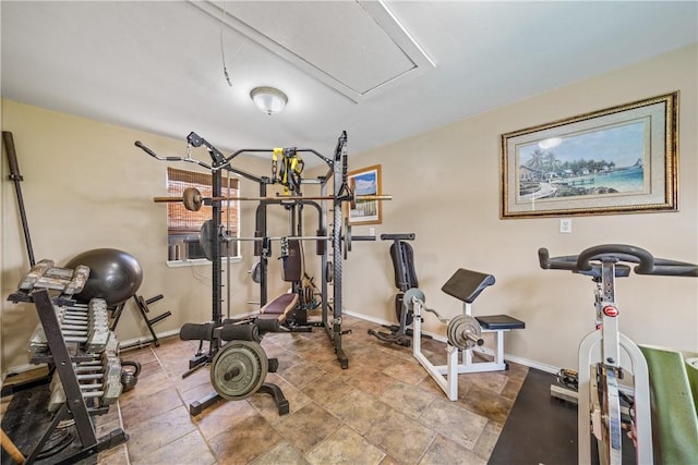 15641 Three Fathoms Bank Dr, Corpus Christi, TX 78418 - workout room featuring attic access, baseboards, and stone finish floors