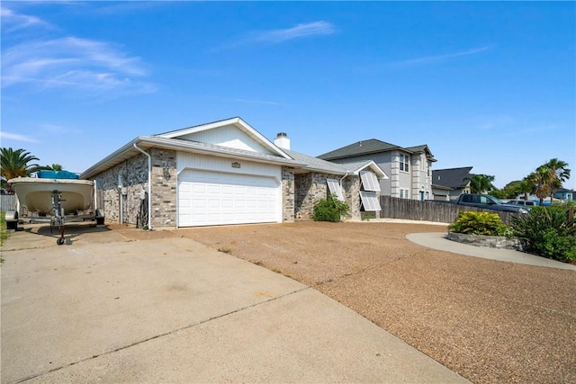 15641 Three Fathoms Bank Dr, Corpus Christi, TX 78418 - view of front of home with concrete driveway, a garage, and a chimney