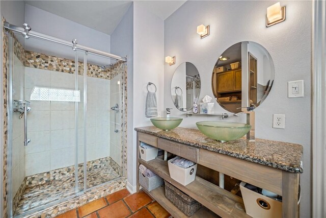 15641 Three Fathoms Bank Dr, Corpus Christi, TX 78418 - bathroom featuring a shower stall, double vanity, and tile patterned flooring