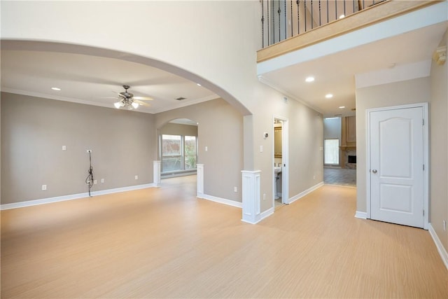 unfurnished room with ceiling fan, ornamental molding, and light wood-type flooring