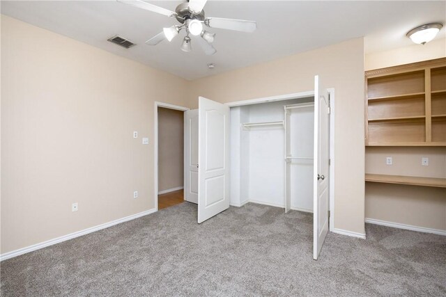 unfurnished bedroom featuring ceiling fan, light carpet, and a closet